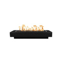 A steel gas fire pit with flames on a patio in the evening