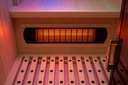 Close-up of Lumin One far-infrared heater panel and bench with LED lighting