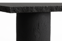 Close-up of the hand-cast matte carbon concrete texture on the Gemini table