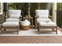 Two Berlin Gardens Camden lounge chairs with ottomans and white cushions on a brick porch