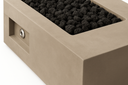 Close-up of the Kenton fire table corner showing concrete texture, black lava rock and stainless ignition button