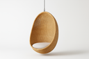 Sika Design natural Alu-Rattan hanging egg chair with white cushion, suspended from a chain
