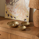 Shah brass nesting bowls styled on a wood console
