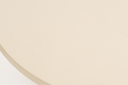 Close-up of the warm white cast concrete tabletop surface on the Uttermost Madrone round dining table