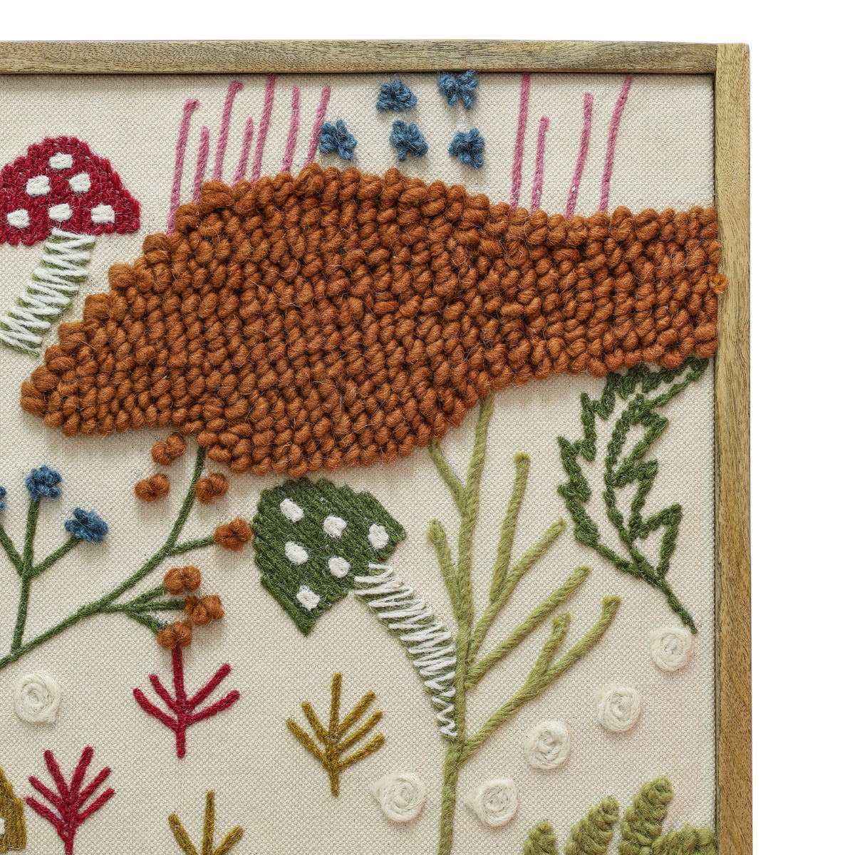 Muro Forage close-up showing the dimensional embroidered mushroom