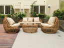 Rattan lounge set with cream cushions on a garden terrace