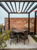 Pergola over a dining set on a walled brick patio