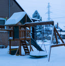 Wooden backyard playset with slide and swings in the snow