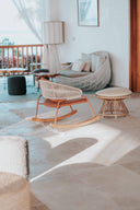 Bright sunroom lounge with a rocking chair and hanging egg chair