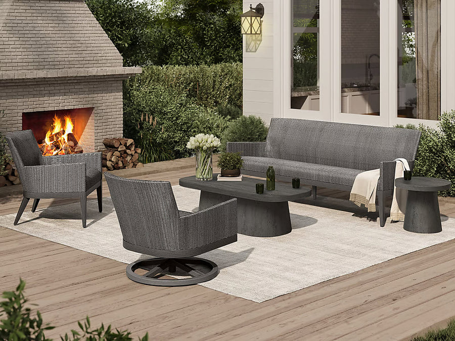 Ebel Siena wicker lounge set with quick-dry cushions beside an outdoor fireplace