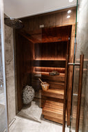 Glass-front sauna beside a shower