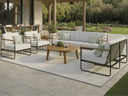 Tropitone Stratton aluminum cushion lounge set with teak arms on a garden patio