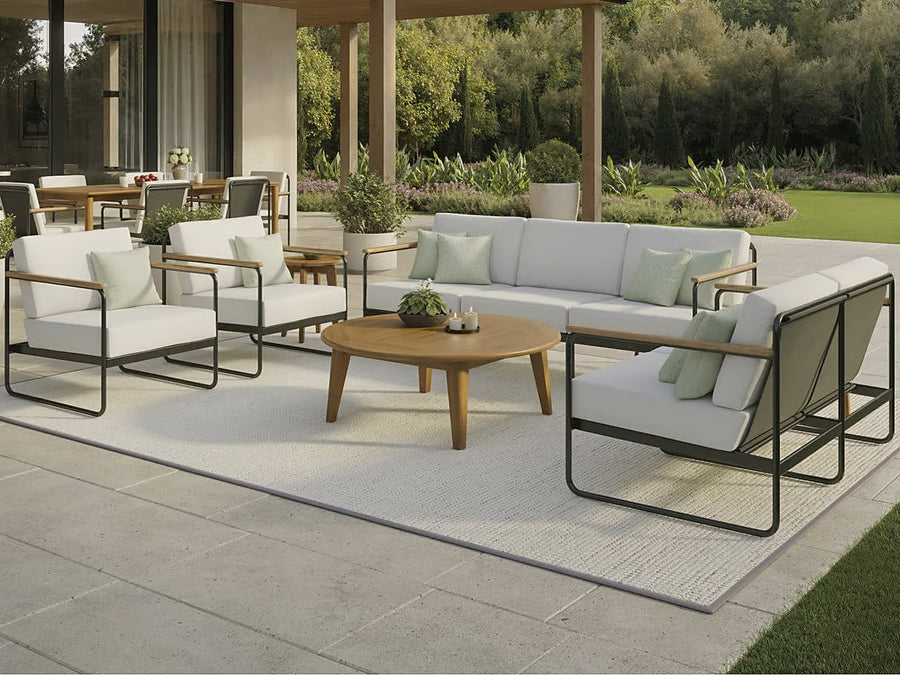Tropitone Stratton aluminum cushion lounge set with teak arms on a garden patio