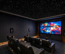 Dark home cinema featuring star ceiling with projection screen